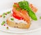 Sandwich with cereals bread and salmon on white plate.