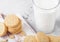 Sandwich cookie consisting of two chocolate wafers with cream filling with glass of milk on stone background