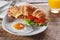 Sandwich croissant with fried bacon cheese tomato breakfast and egg