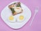 Sandwich with edible chicken made of egg on pink background. Food art idea. Kidâ€™s breakfast