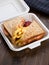 Sandwich with french fries packed in plastic box for lunch