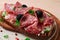 Sandwich , grain bread, with cream cheese and salami, black olives, micro-greens, top view, close-up, no people