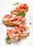 Sandwich with grilled country bread with the addition of smoked ham and capers