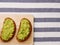 Sandwich with guacamole on light textile background top view. sandwiches on wooden board