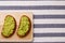 Sandwich with guacamole on light textile background top view. sandwiches on wooden board