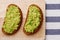 Sandwich with guacamole on light textile background top view. sandwiches on wooden board