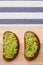 Sandwich with guacamole on light textile background top view. sandwiches on wooden board