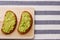 Sandwich with guacamole on light textile background top view. sandwiches on wooden board