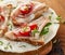 Sandwich with ham, cherry tomatoes, cheese, fresh savory and lamb\'s lettuce