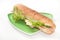 Sandwich with ham and letuce on the green plate