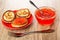 Sandwich from pancake with caviar in saucer, spoon in bowl with imitation red caviar, fork on table