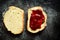 Sandwich with raspberry jam. Sandwich on a dark background isolated. Delicious raspberry and strawberry jam. Place for text. Top