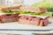 Sandwich with roast beef, cheese, mustard and