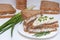 Sandwich with rye brown bread with seeds, fish, green onion. Healthy snack