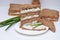 Sandwich with rye brown bread with seeds, fish, green onion. Healthy snack