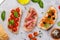 Sandwich set of bruschetta with juicy tomatoes, cheese and prosciutto