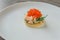 Sandwich with shrimps and caviar on white plate on dark stone table. Toast skagen - classic Swedish appetizer. Healthy food