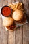 Sandwich Sloppy Joes with sauce and French fries close-up on the