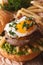 Sandwich with steak, fried egg and French fries close-up. vertic