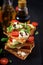 Sandwich toasts with tomatoes, mozzarella, avocado and basil