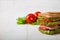 Sandwich, tomato, toast, salad on white wooden background