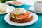 Sandwich with whole grain bread, goat cheese, fresh tomatoes and poached egg.