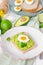 Sandwich with whole grain bread, mashed avocado and boiled eggs