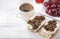 Sandwiches with cheese and mushrooms,  Cup of black coffee, grapes on a white ,  delicious, healthy Breakfast, copy space