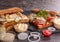Sandwiches with chicken meat, cherry tomato, onion and chicken meat, marinated cucumbers, mozzarella cheese on  black background