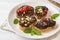 Sandwiches with chocolate paste, pistachio nuts and fresh berries on a plate.