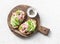 Sandwiches with cream cheese, avocado and tuna fish on wooden cutting board on white background, top view. Healthy breakfast