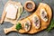 Sandwiches with cream cheese and garlic edible flowers, olive board