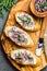 Sandwiches with cream cheese and garlic edible flowers, olive board