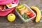 Sandwiches, fruits and vegetables in food box, backpack