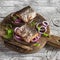 Sandwiches with grilled fish and quick pickled onions