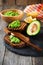 Sandwiches with guacamole traditional Mexican sauce, avocado and lemon on old wooden background.