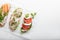 Sandwiches with ham, radish, romano salad, baby basil, mascarpone cheese, caprese salad on a white background. copy space. top