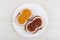 Sandwiches with ham sausage, ketchup and squash caviar in white plate on wooden table