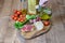 Sandwiches with jamon, olive oil dripping on the slice of bread and some vegetables on the wooden kitchen background. Healthy food