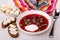 Sandwiches with lard, napkin, borscht with parsley, sour cream in plate, spoon