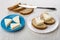 Sandwiches with melted cheese, cheese in saucer, table knife, br