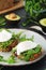 Sandwiches with pesto, poached eggs and green salad