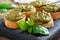 Sandwiches with pesto sauce, fresh basil leaves and garlic. A delicious healthy snack. Wooden rustic background. close up