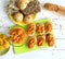 Sandwiches with pumpkin dip and bread buns with various seeds on white wooden table.