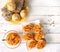 Sandwiches with pumpkin dip and bread buns with various seeds on white wooden table.