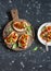 Sandwiches with quick ratatouille on rustic cutting board on a dark background. Delicious healthy vegetarian food.