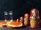 Sandwiches with red caviar of salmon fish. A glass of vodka, matryoshka. The concept of Russian tradition. Copy space