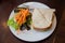 Sandwiches and salads on a white plate.