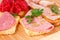 Sandwiches with salami, bacon and mortadella