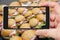 Sandwiches in smartphone screen.  Cold appetizers on tray.